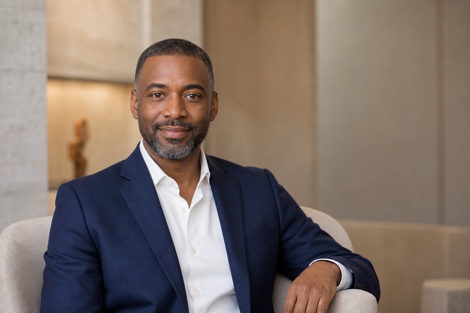Professional seated headshot in an office setting.